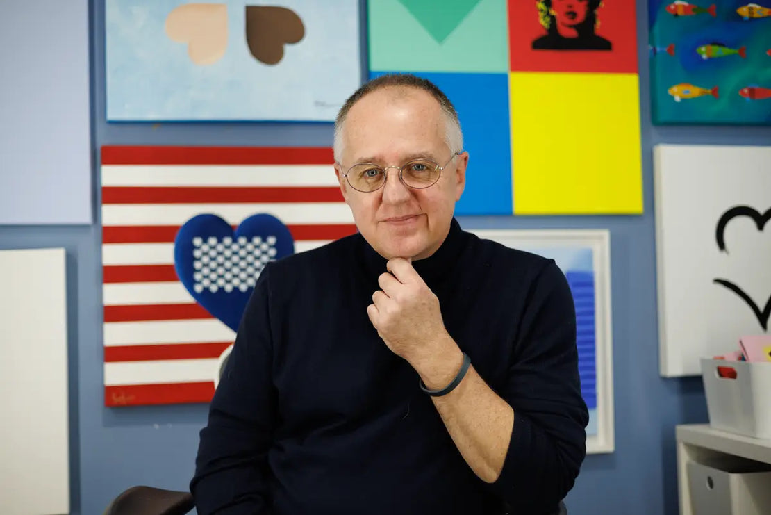 Sam Grudge in his studio with paintings